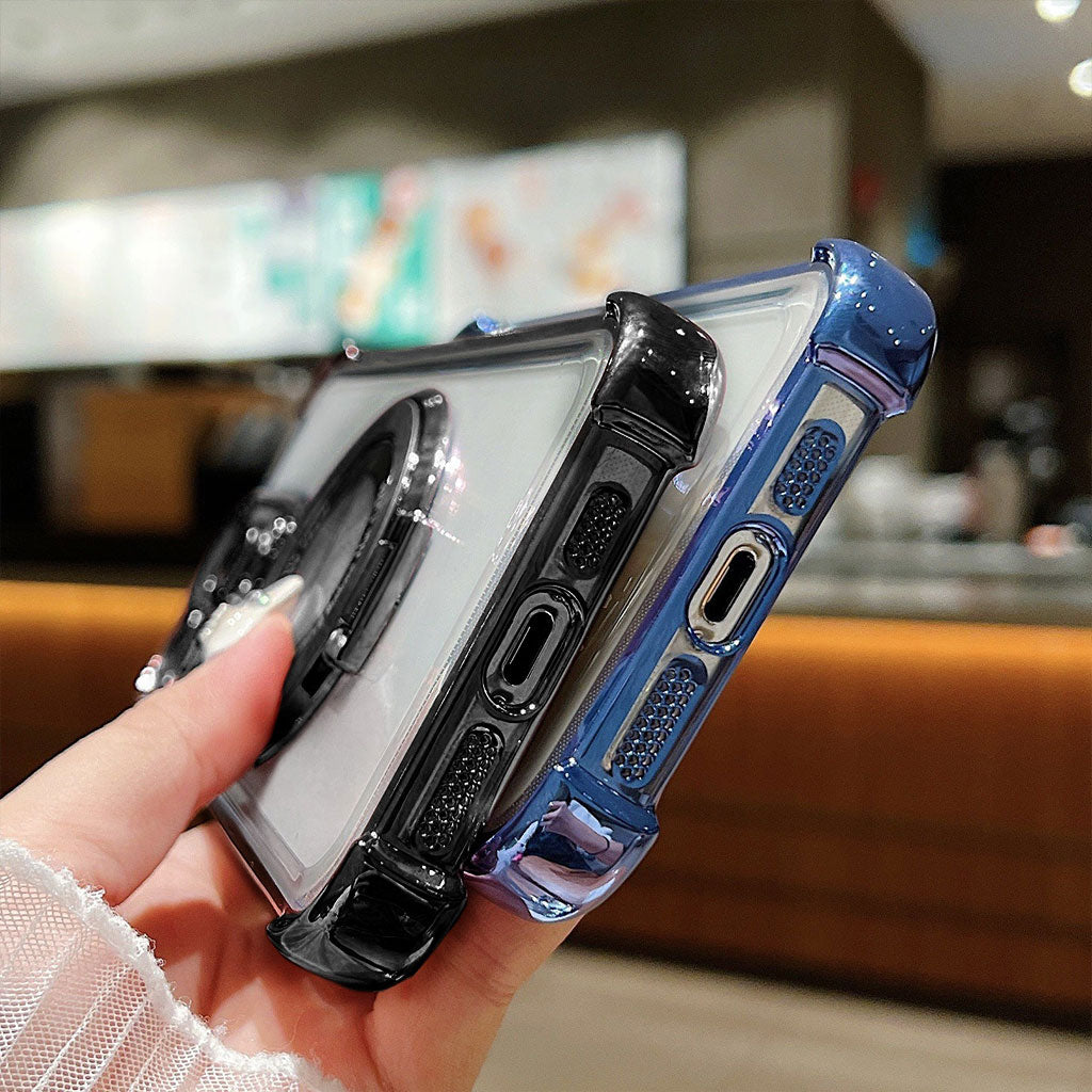 Hand holding two phone cases with a blurred indoor background